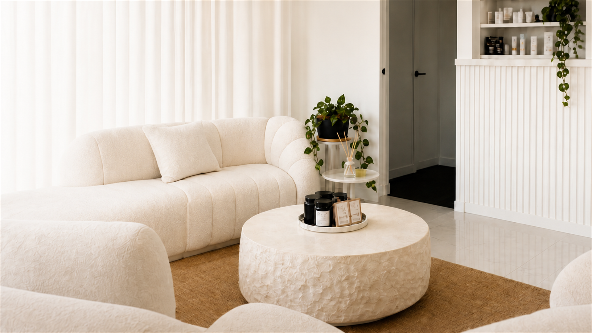 Cream salon lounge with a boucle sofa and marble table