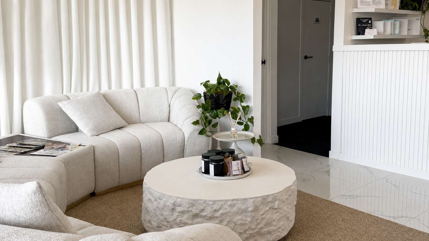 Wide view of the cream salon interior with arch reception and lounge